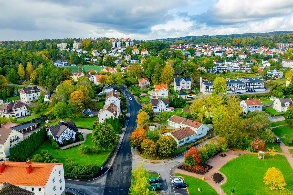 Riverside view of central Borås with the Viskan, cafés, and pedestrians on a sunny day.