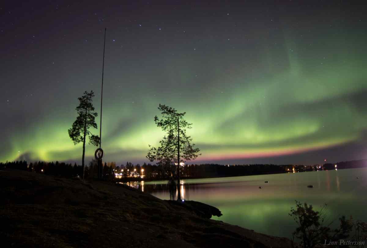 Aurora borealis over a lake near northern Swedish villages